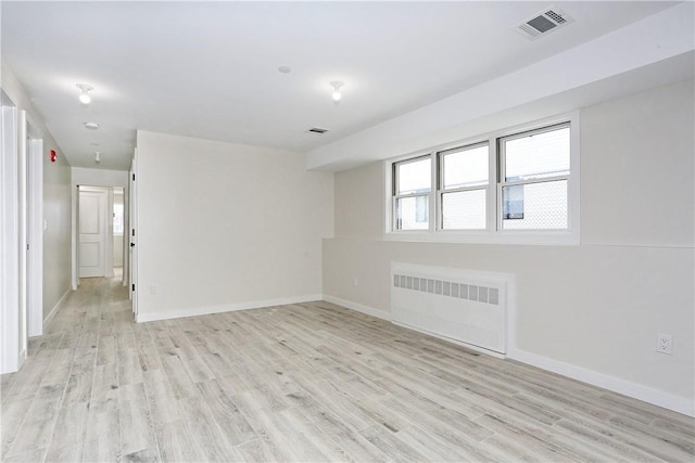 33 Ewing Ave Unit 102, Spring Valley, NY 10977 - empty room featuring radiator heating unit and light wood-type flooring