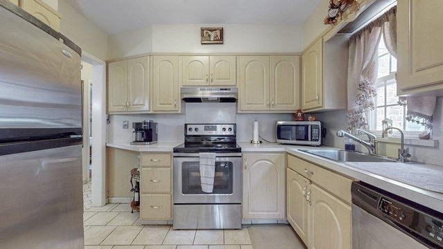46-03 195th St, Flushing, NY 11358 - kitchen featuring appliances with stainless steel finishes, under cabinet range hood, light countertops, and light tile patterned floors