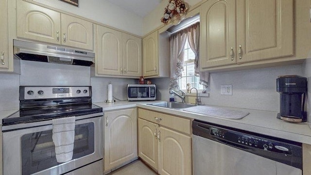 46-03 195th St, Flushing, NY 11358 - kitchen featuring appliances with stainless steel finishes, under cabinet range hood, light countertops, and cream cabinets