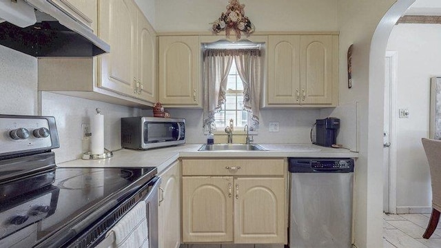46-03 195th St, Flushing, NY 11358 - kitchen featuring appliances with stainless steel finishes, custom exhaust hood, arched walkways, light countertops, and cream cabinetry