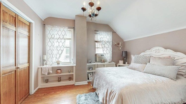 46-03 195th St, Flushing, NY 11358 - bedroom with light wood-type flooring, vaulted ceiling, and a chandelier
