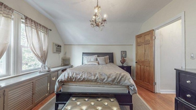 46-03 195th St, Flushing, NY 11358 - bedroom featuring vaulted ceiling, light wood-style flooring, a wall unit AC, and a chandelier