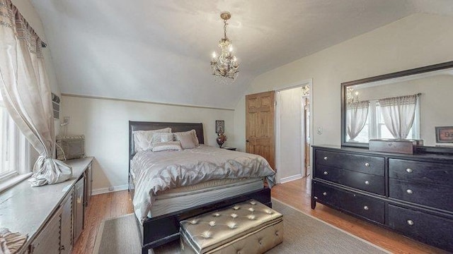 46-03 195th St, Flushing, NY 11358 - bedroom with lofted ceiling, wood finished floors, and a chandelier