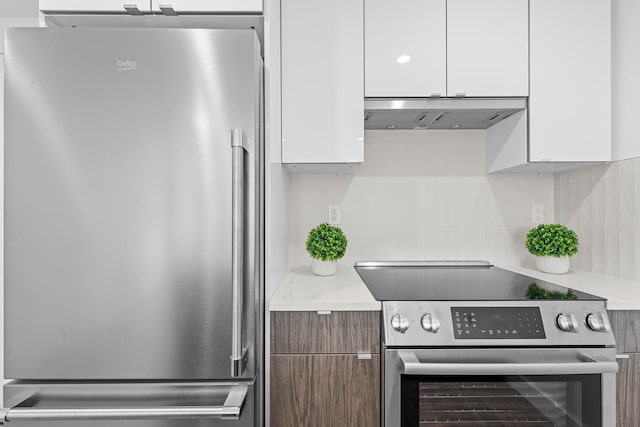 46-40 Vernon Blvd Unit 2A, Long Island City, NY 11101 - kitchen with appliances with stainless steel finishes, extractor fan, white cabinets, and light countertops