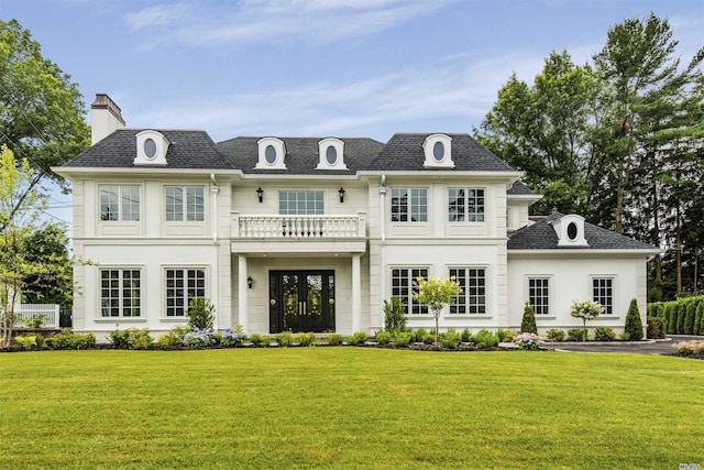 272 Crabapple Rd, Manhasset, NY 11030 - rear view of property featuring a lawn, a chimney, a balcony, and stucco siding