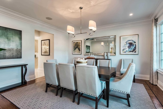 272 Crabapple Rd, Manhasset, NY 11030 - dining space with crown molding, dark wood finished floors, and a chandelier