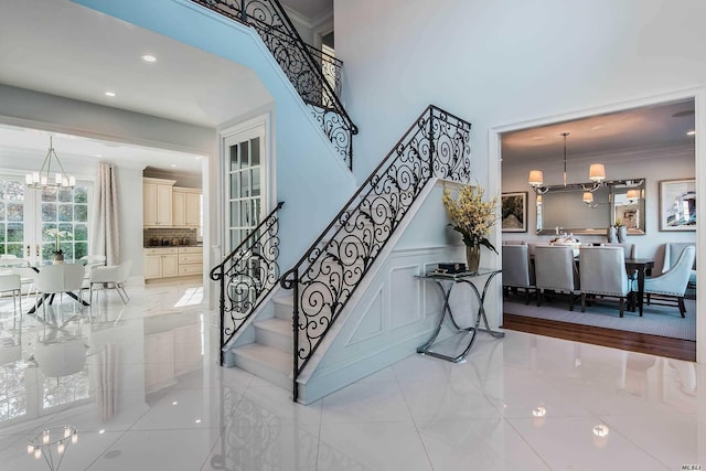 272 Crabapple Rd, Manhasset, NY 11030 - staircase featuring a chandelier, ornamental molding, tile patterned floors, recessed lighting, and a decorative wall