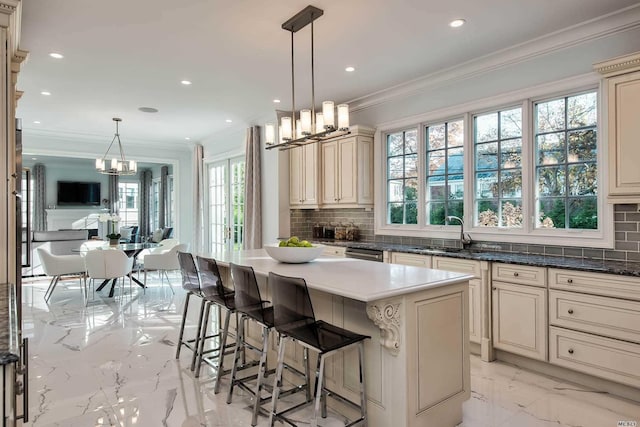 272 Crabapple Rd, Manhasset, NY 11030 - kitchen featuring cream cabinets, a chandelier, light marble finish floors, healthy amount of natural light, and recessed lighting