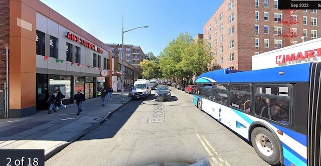 14330 Roosevelt Unit 5J, Flushing, NY 11354 - view of asphalt road featuring street lighting, sidewalks, and curbs