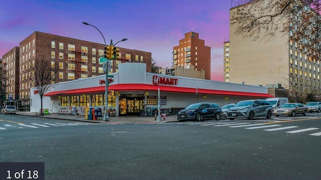 14330 Roosevelt Unit 5J, Flushing, NY 11354 - property at dusk featuring uncovered parking and view of commercial area