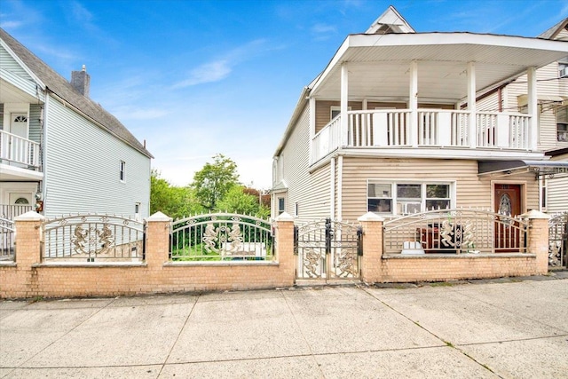 1519 Rosedale Ave, Bronx, NY 10460 - view of side of home with a balcony, a gate, and a fenced front yard
