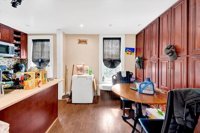 1519 Rosedale Ave, Bronx, NY 10460 - kitchen with dark wood-type flooring, stainless steel microwave, refrigerator, light countertops, and tasteful backsplash