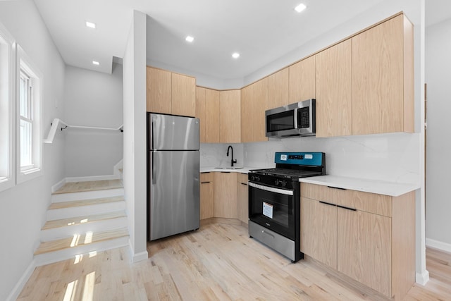 1276 E 59th St, Brooklyn, NY 11234 - kitchen featuring appliances with stainless steel finishes, light brown cabinets, modern cabinets, light countertops, and light wood finished floors