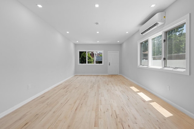 1276 E 59th St, Brooklyn, NY 11234 - empty room featuring a wall unit AC, light wood-style flooring, and recessed lighting