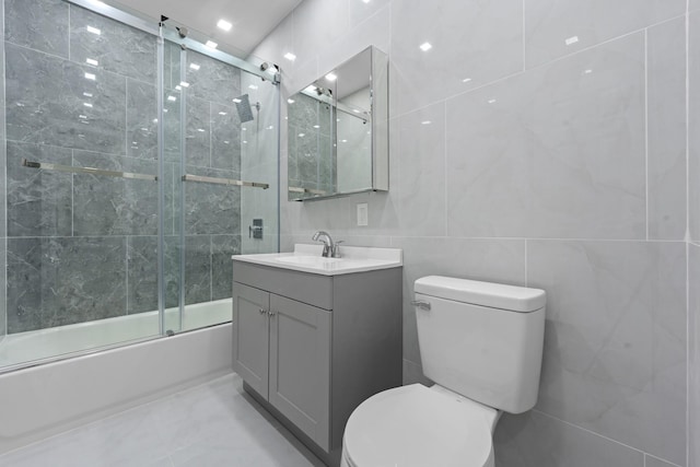 1276 E 59th St, Brooklyn, NY 11234 - bathroom featuring vanity, tile walls, and shower / bath combination with glass door