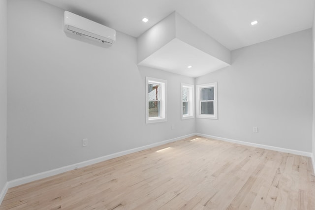 1276 E 59th St, Brooklyn, NY 11234 - empty room with a wall unit AC, light wood-style floors, and recessed lighting