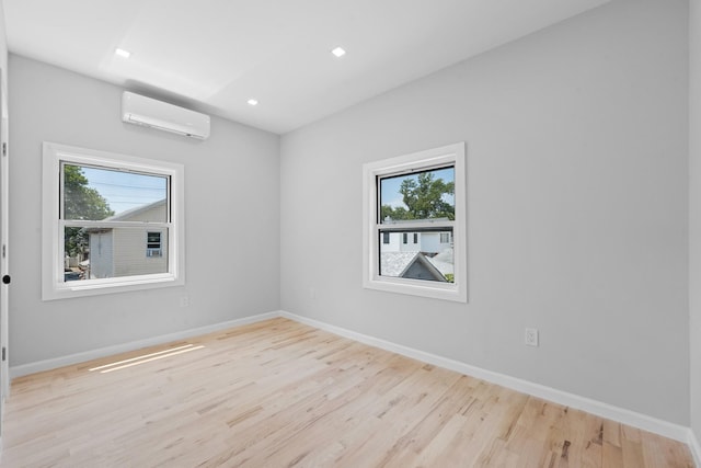 1276 E 59th St, Brooklyn, NY 11234 - empty room featuring a wall unit AC, plenty of natural light, wood finished floors, and recessed lighting