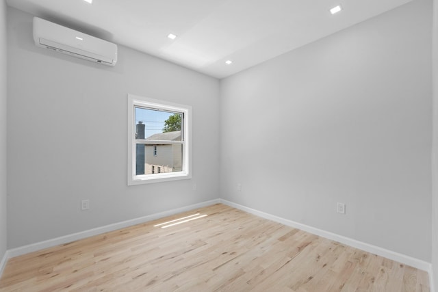 1276 E 59th St, Brooklyn, NY 11234 - spare room featuring a wall unit AC, wood finished floors, and recessed lighting