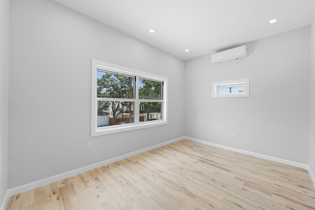 1276 E 59th St, Brooklyn, NY 11234 - unfurnished room with an AC wall unit, healthy amount of natural light, wood finished floors, and recessed lighting