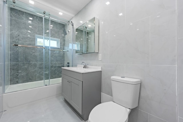 1276 E 59th St, Brooklyn, NY 11234 - full bathroom featuring tile walls, vanity, and bath / shower combo with glass door