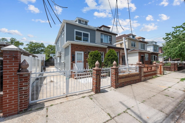 1276 E 59th St, Brooklyn, NY 11234 - view of front of house with a gate, a fenced front yard, brick siding, and a residential view