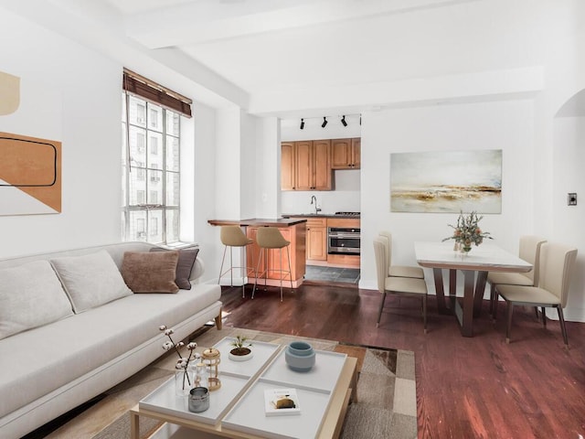 340 W 57th St Unit 5F, New York Manhattan, NY 10019 - living room with dark wood-style floors, track lighting, and arched walkways