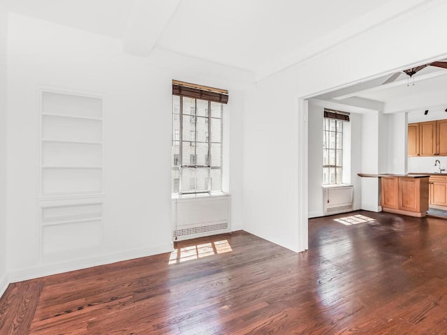 340 W 57th St Unit 5F, New York Manhattan, NY 10019 - unfurnished living room featuring dark wood finished floors, built in features, and ceiling fan
