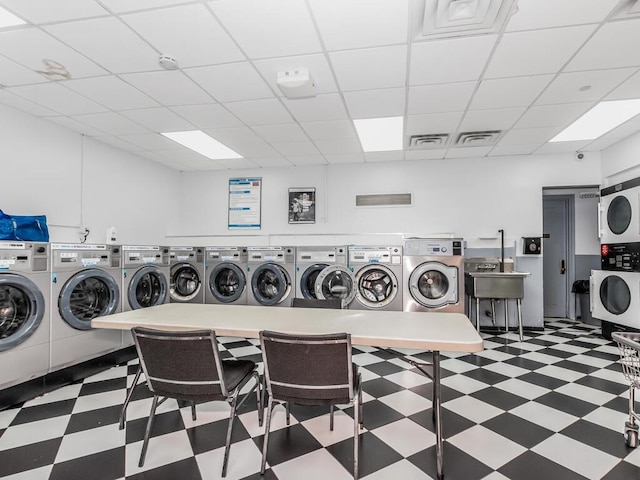 340 W 57th St Unit 5F, New York Manhattan, NY 10019 - shared laundry room featuring stacked washer / drying machine, tile patterned floors, and washing machine and clothes dryer