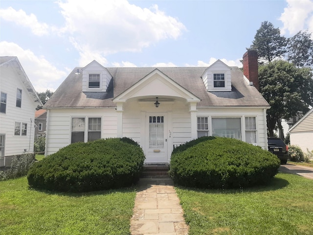 52 Fountain Pl, Poughkeepsie, NY 12603 - cape cod house featuring a front yard, a chimney, entry steps, and a shingled roof