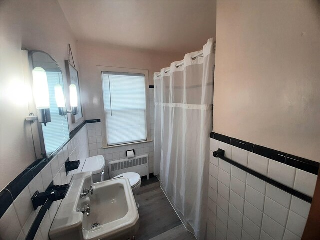 52 Fountain Pl, Poughkeepsie, NY 12603 - full bathroom featuring tile walls, radiator, a wainscoted wall, a shower with shower curtain, and wood finished floors
