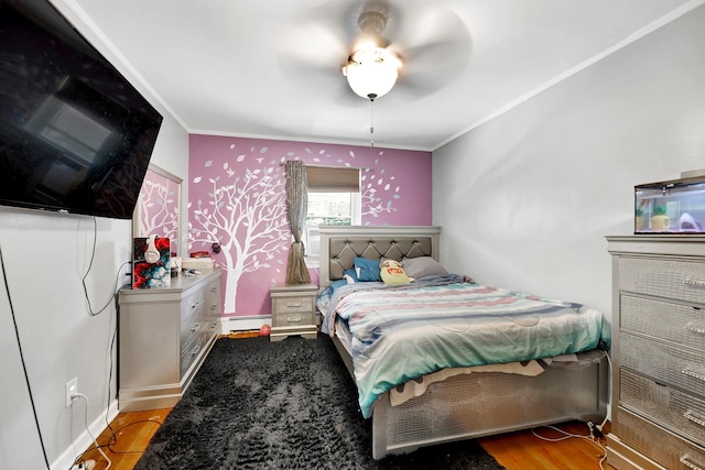 946 Balcom Ave, Bronx, NY 10465 - bedroom featuring a baseboard radiator, crown molding, wood finished floors, and ceiling fan