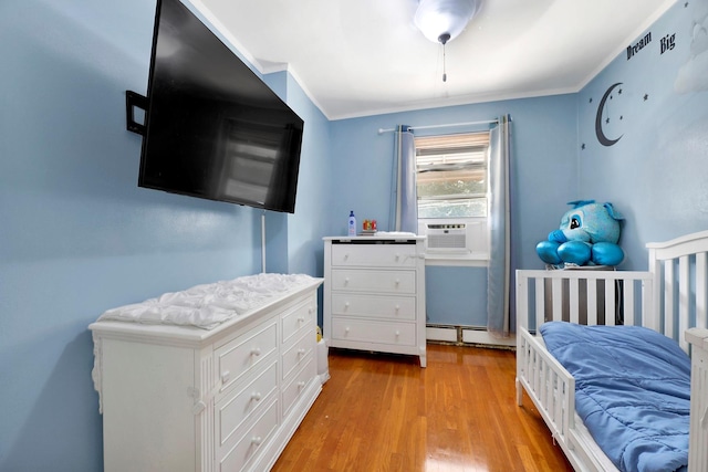946 Balcom Ave, Bronx, NY 10465 - bedroom with light wood-style floors, cooling unit, and ornamental molding