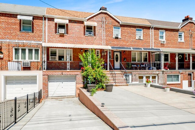 946 Balcom Ave, Bronx, NY 10465 - view of front of home featuring brick siding, concrete driveway, and a garage