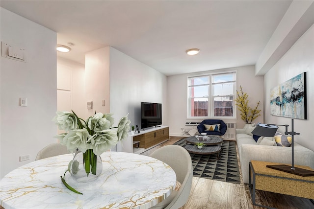 50-22 40th St Unit 2F, Sunnyside, NY 11104 - living area with wood finished floors and an AC wall unit