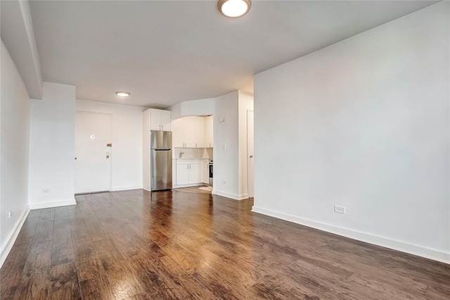 50-22 40th St Unit 2F, Sunnyside, NY 11104 - unfurnished living room featuring dark wood finished floors and baseboards