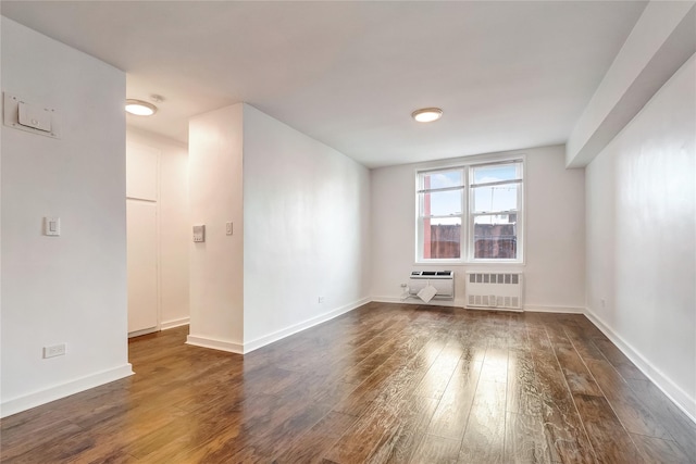 50-22 40th St Unit 2F, Sunnyside, NY 11104 - unfurnished room with radiator, dark wood-type flooring, and a wall unit AC