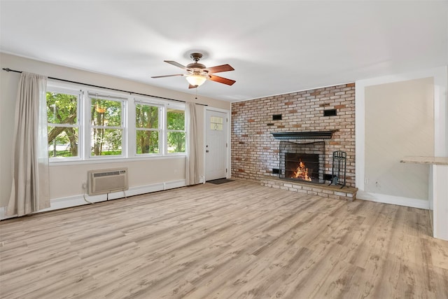 68 Gerald Dr Unit D1, Poughkeepsie, NY 12601 - unfurnished living room with a wall mounted air conditioner, wood finished floors, ceiling fan, and a fireplace