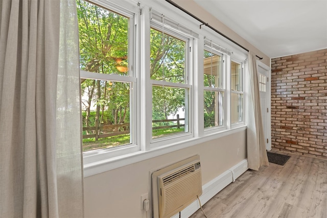 68 Gerald Dr Unit D1, Poughkeepsie, NY 12601 - unfurnished sunroom featuring brick wall, plenty of natural light, wood finished floors, and an AC wall unit