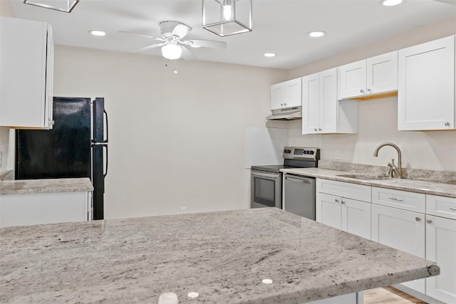 68 Gerald Dr Unit D1, Poughkeepsie, NY 12601 - kitchen with under cabinet range hood, stainless steel appliances, white cabinetry, ceiling fan, and light stone countertops