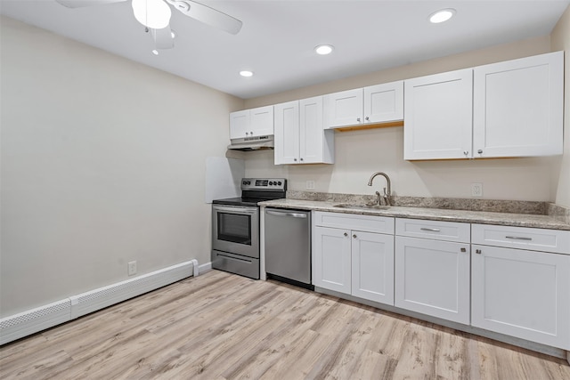 68 Gerald Dr Unit D1, Poughkeepsie, NY 12601 - kitchen with appliances with stainless steel finishes, under cabinet range hood, a baseboard heating unit, light wood-type flooring, and ceiling fan
