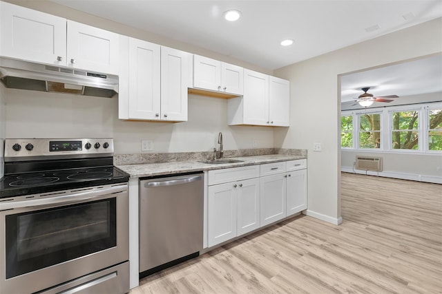 68 Gerald Dr Unit D1, Poughkeepsie, NY 12601 - kitchen featuring appliances with stainless steel finishes, under cabinet range hood, light wood-type flooring, white cabinetry, and a ceiling fan