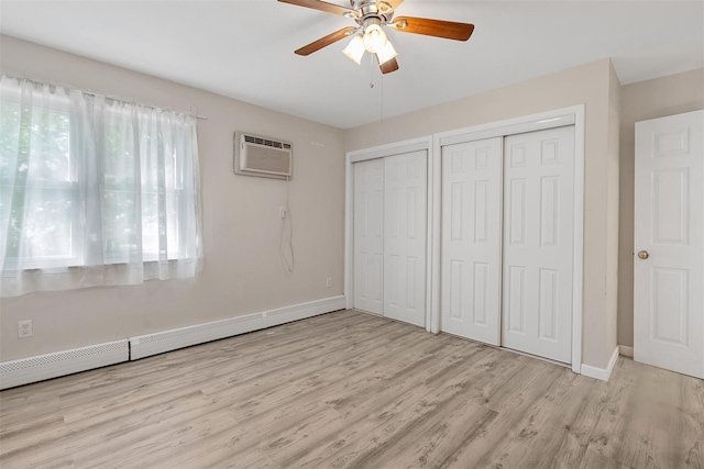 68 Gerald Dr Unit D1, Poughkeepsie, NY 12601 - unfurnished bedroom featuring a wall mounted air conditioner, multiple closets, wood finished floors, a baseboard radiator, and ceiling fan