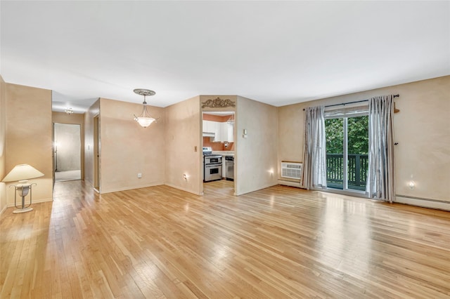 54 Fairharbor Dr Unit 54, Patchogue, NY 11772 - unfurnished living room with light wood-style floors and an AC wall unit