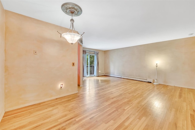 54 Fairharbor Dr Unit 54, Patchogue, NY 11772 - spare room featuring light wood-style flooring and a baseboard radiator