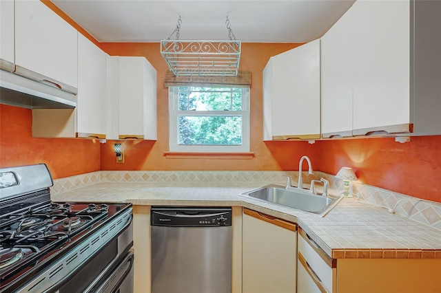 54 Fairharbor Dr Unit 54, Patchogue, NY 11772 - kitchen with range with gas cooktop, stainless steel dishwasher, light countertops, white cabinetry, and exhaust hood