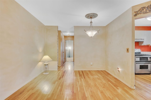 54 Fairharbor Dr Unit 54, Patchogue, NY 11772 - unfurnished dining area with light wood-type flooring and baseboards