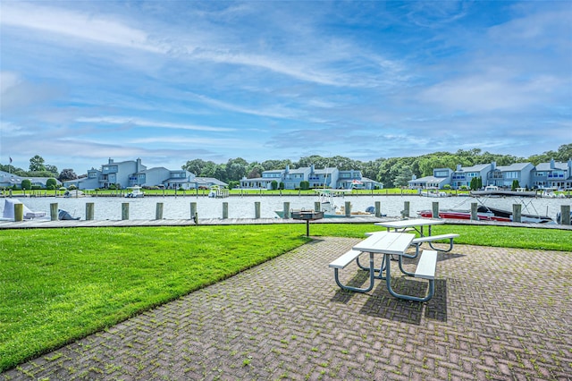 54 Fairharbor Dr Unit 54, Patchogue, NY 11772 - view of patio / terrace with a boat dock and a residential view
