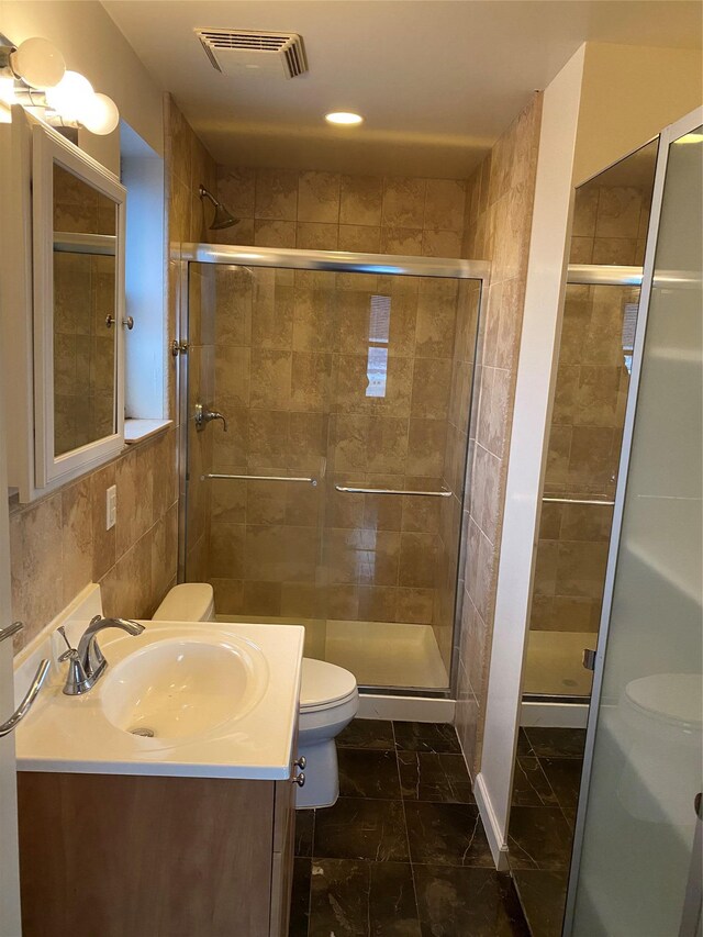 3138 137th St Unit 9B, Flushing, NY 11354 - bathroom with vanity, a shower stall, and tile walls