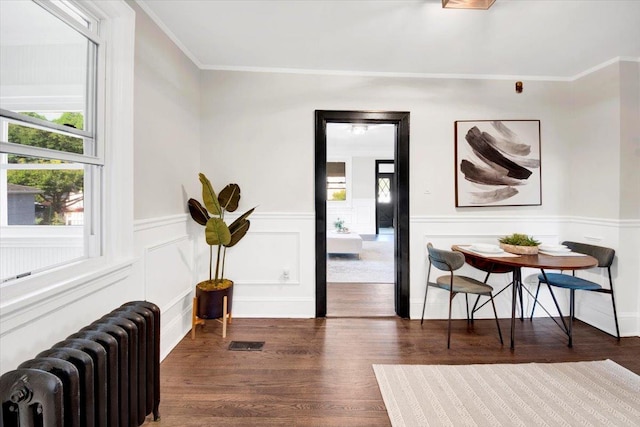 4 Cedar St, Hastings-On-Hudson, NY 10706 - living area featuring radiator heating unit, crown molding, dark wood-type flooring, and a wainscoted wall
