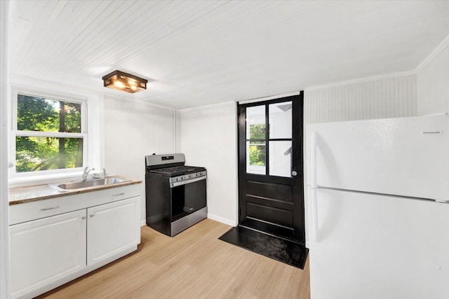 4 Cedar St, Hastings-On-Hudson, NY 10706 - kitchen featuring gas range, freestanding refrigerator, light wood finished floors, plenty of natural light, and crown molding